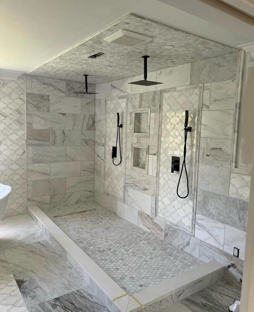 a bathroom with marble tile walls and shower