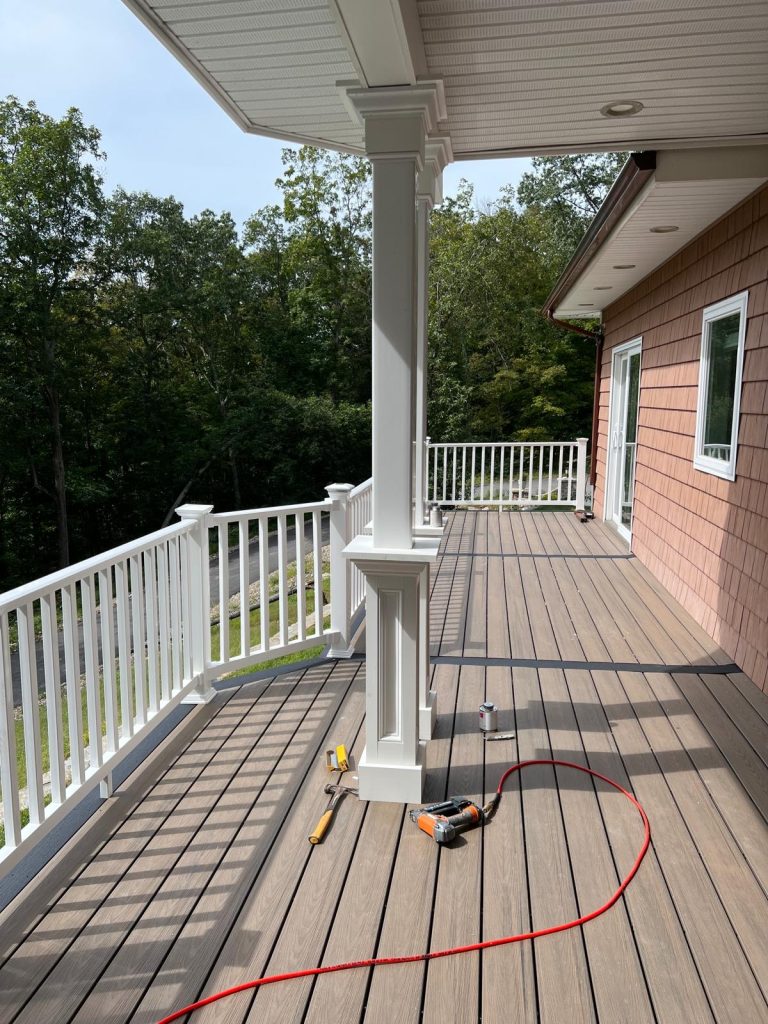 a deck with a white railing and a white railing and a white railing
