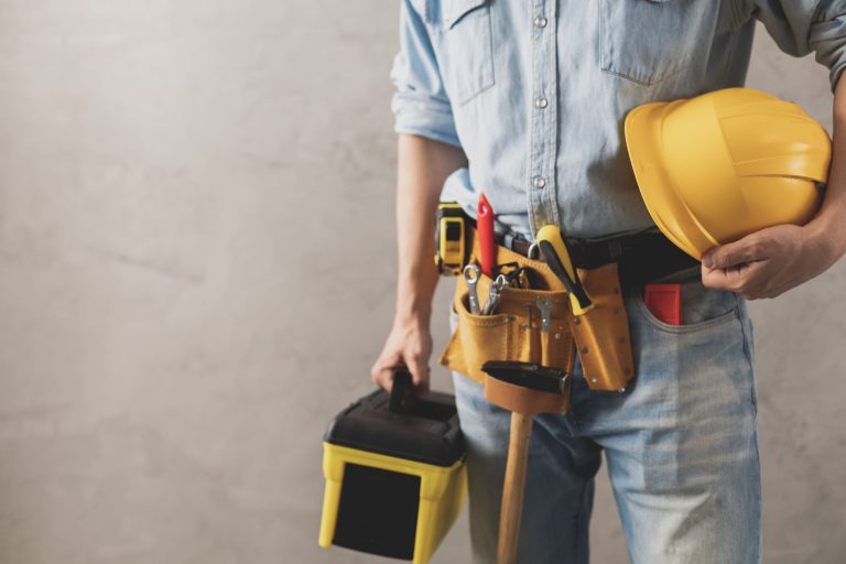 worker man holding construction helmet and toolbox